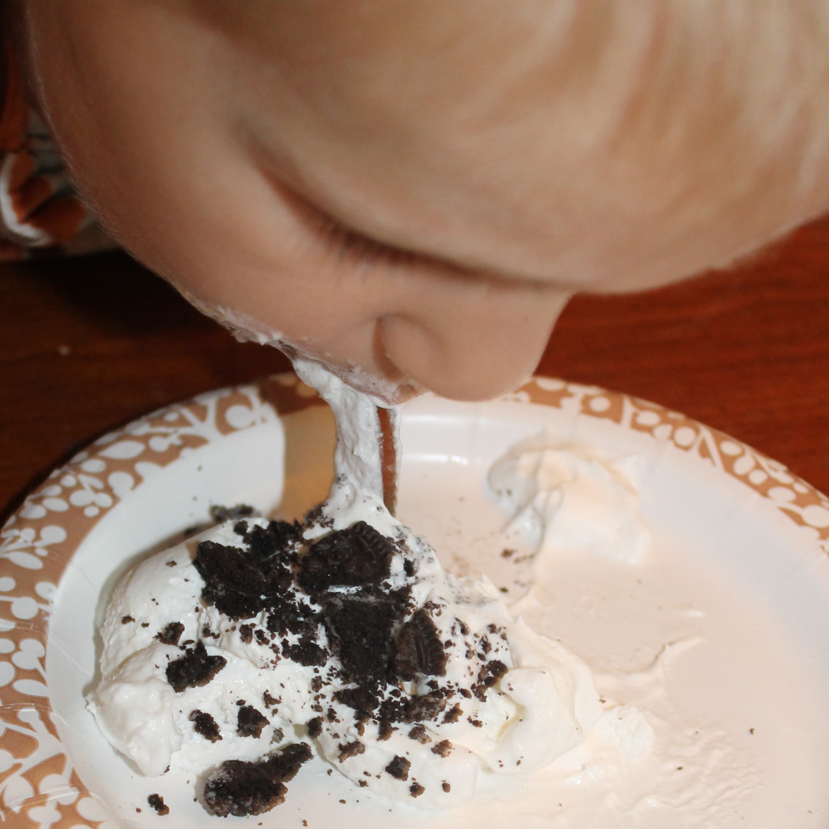 Diet of Worms - Retrieving gummy worms from a plate of Cool Whip and Oreo cookies 