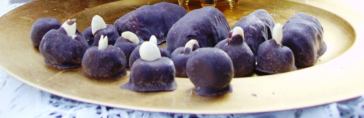 Homemade marzipan covered with dark chocolate and with an almond at the top