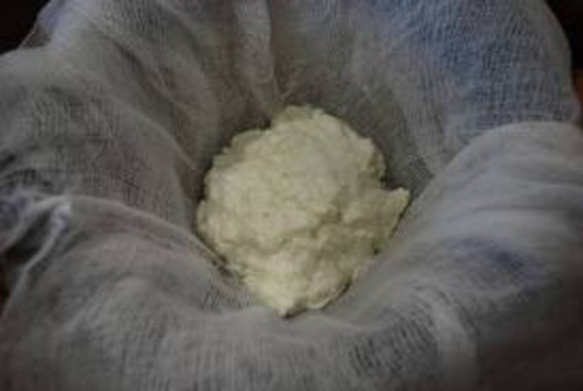 Spoon the curds into a cheesecloth placed in a colander for draining