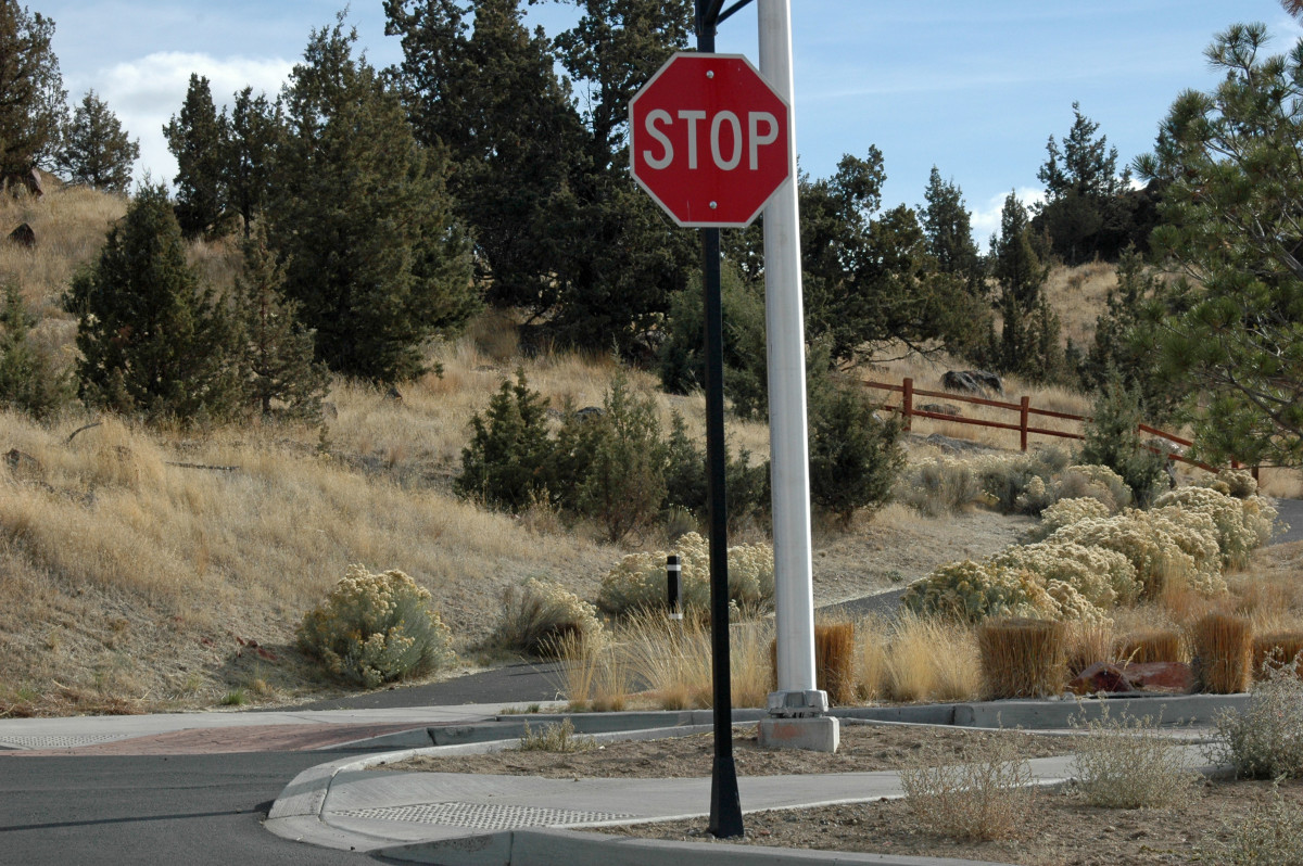 Go straight through the stop sign and hit the asphalt trail to reach the trail head