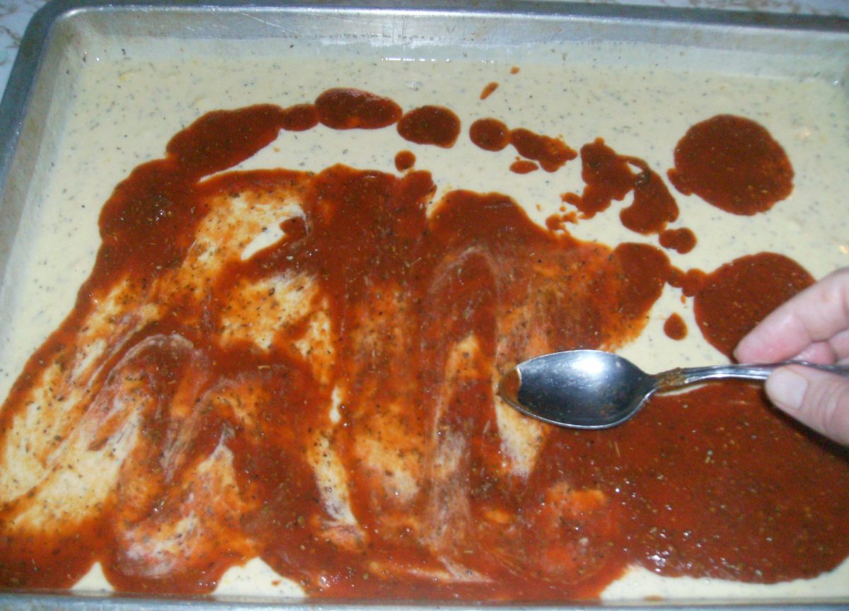 Spread the sauce gently over the uncooked crazy crust.