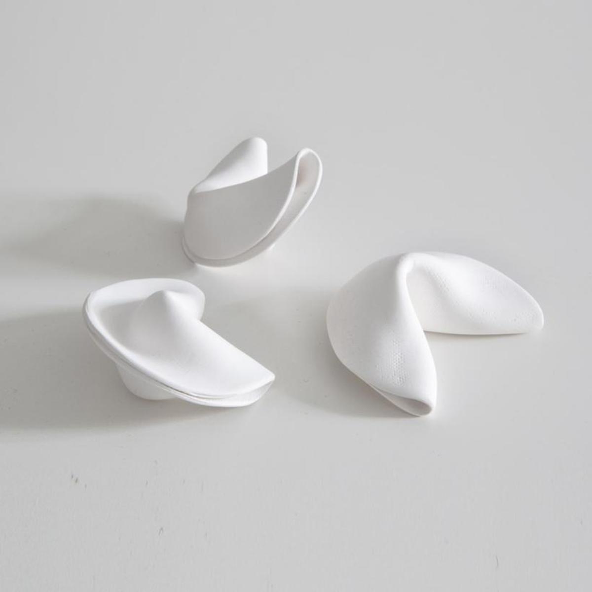 I couldn't find a tutorial for this, but you can purchase porcelain fortune cookies.