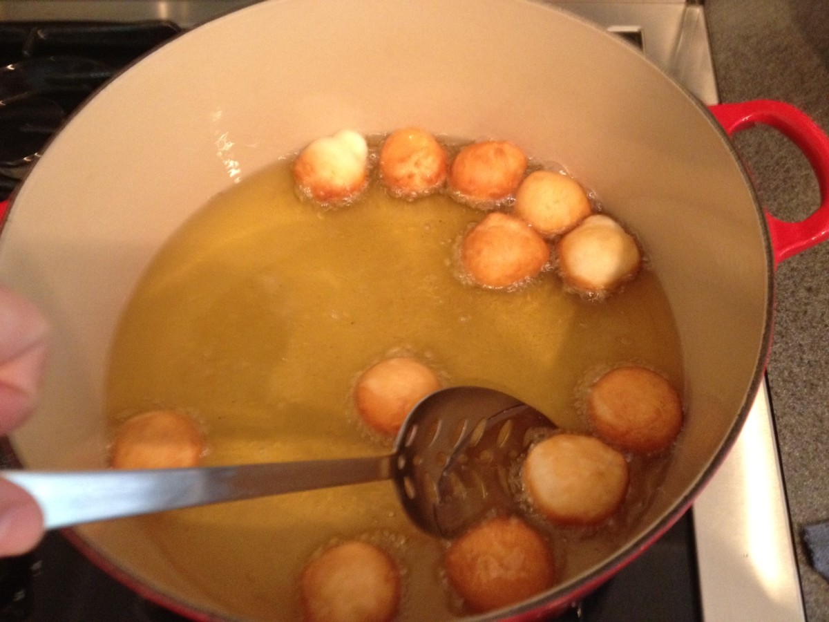 Use a slotted spoon to turn and remove your beignets from the fry oil.