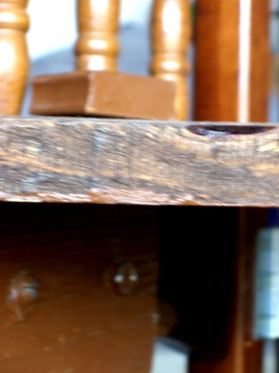 Peg slips through hole and into 2x6 section screwed to rail underneath -