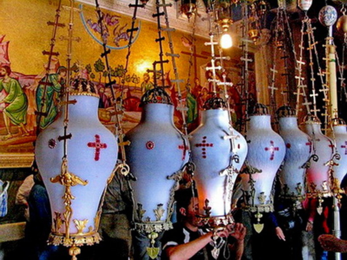 The lamps that hang over the stone are contributed by Armenians, Copts, Greeks and Latins (Roman Catholic) 