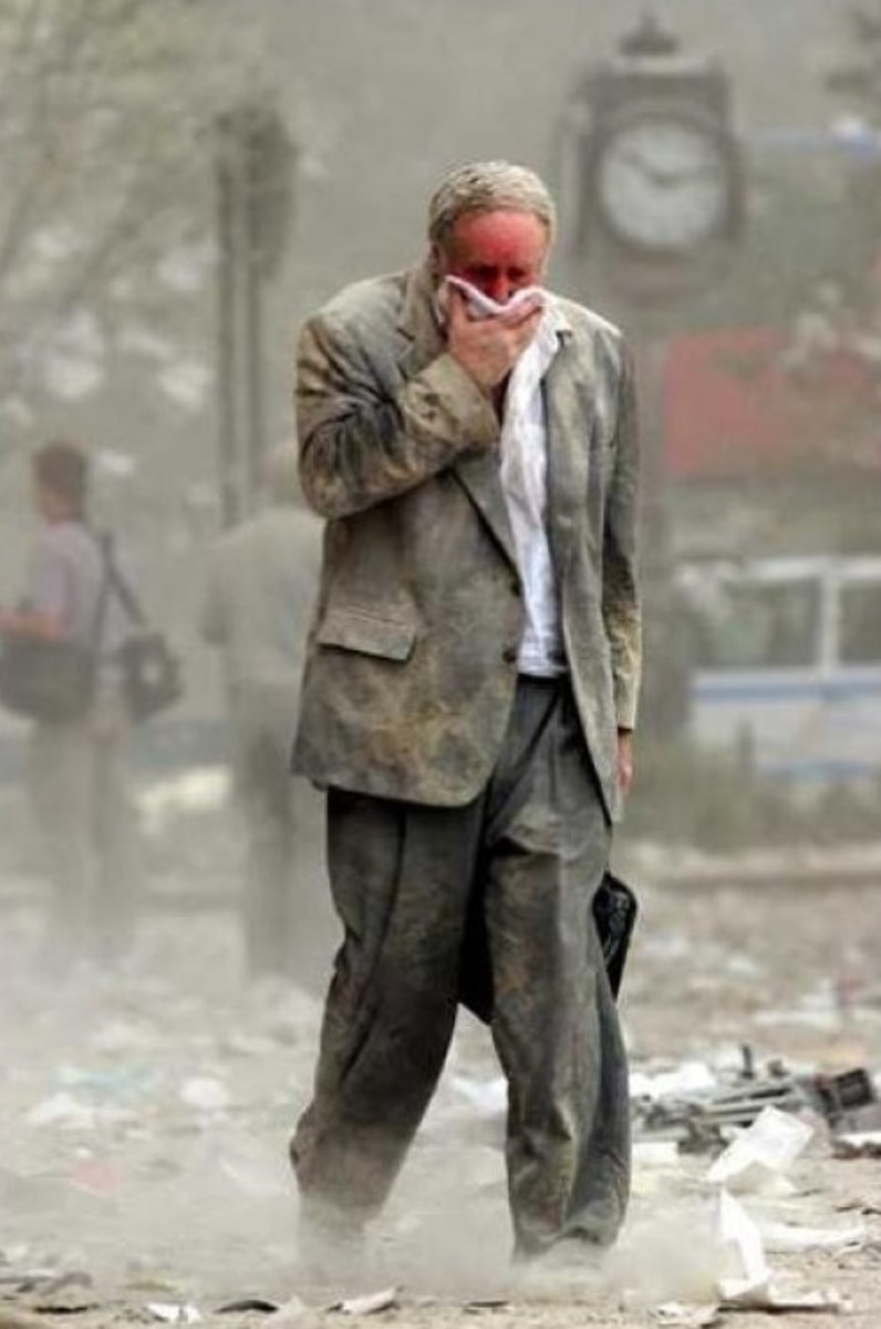 10:10AM - A man moves through the 9/11 debris which is everywhere - and stayed everywhere for months -- while people lived, worked, ate, and slept, breathing it all in. The man, Edward Fine, an owner of a public relations firm, was going to work