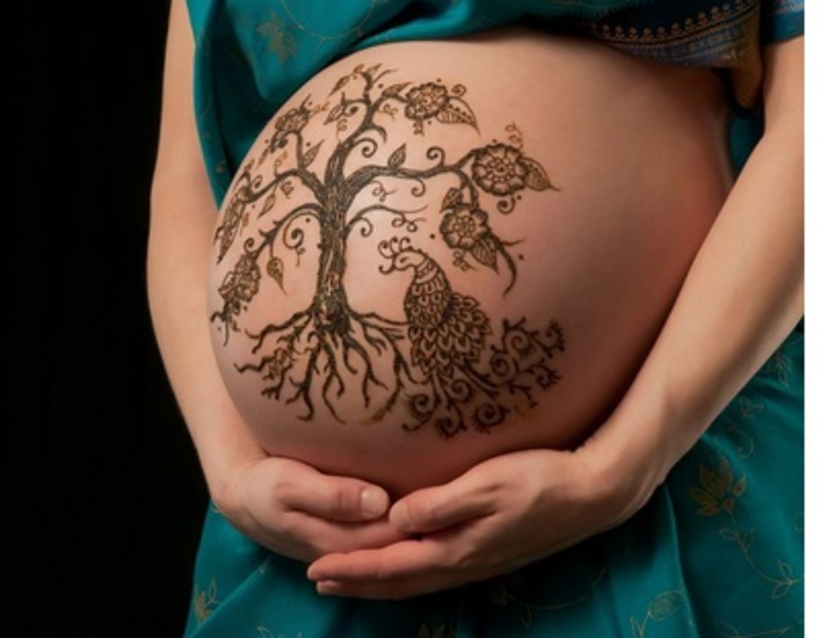 A woman with tattoo on pregnant stomach, is an  abuse of  tattoo