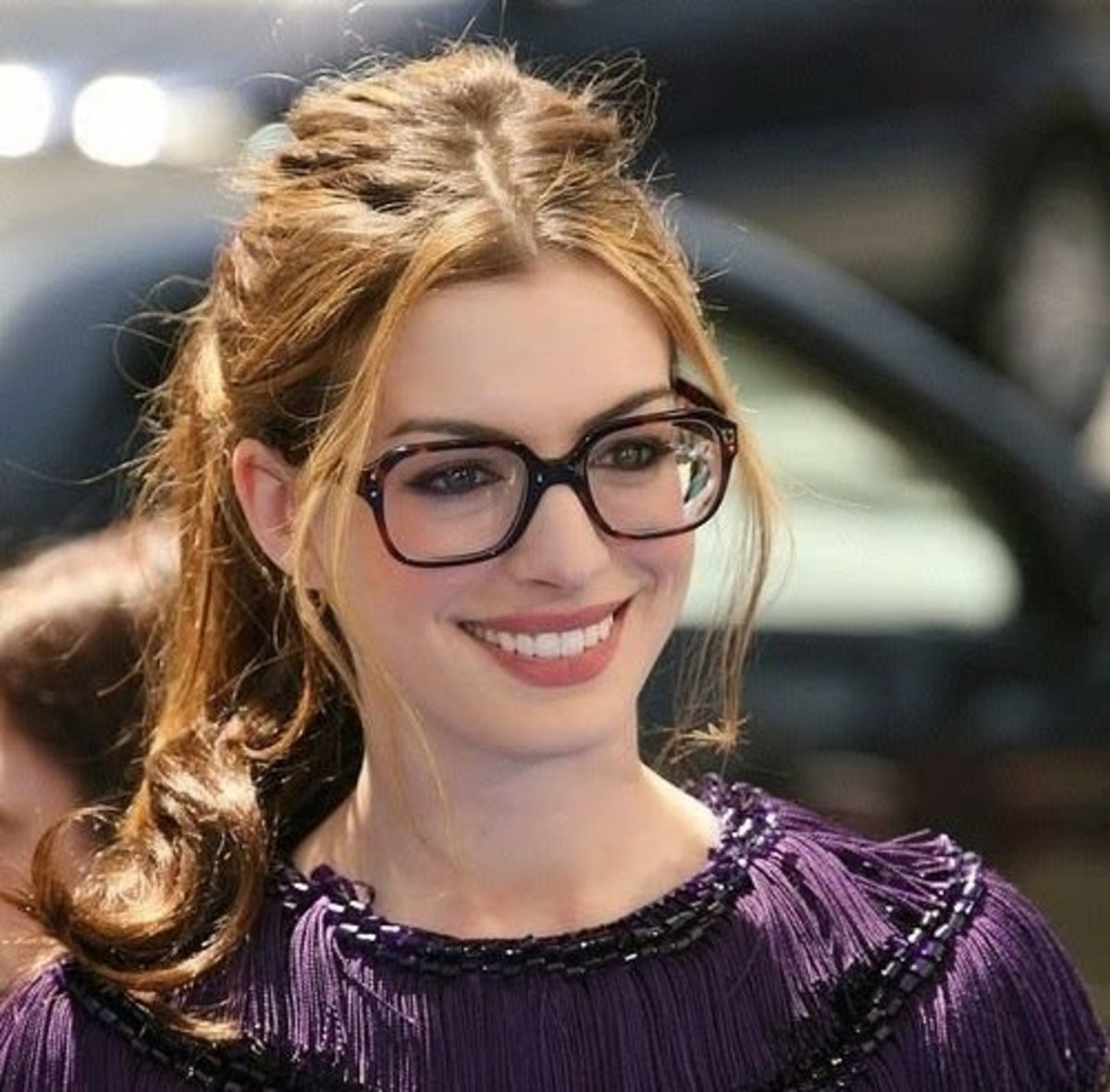 Anne Hathaway wearing bold dark framed glasses