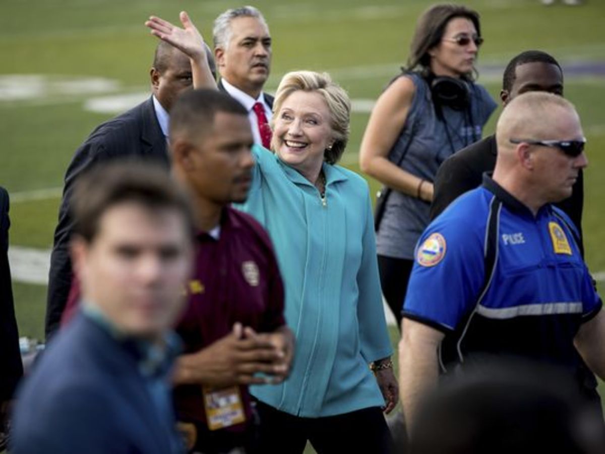 Hillary Clinton desperately waves to her ever-diminishing fan base.