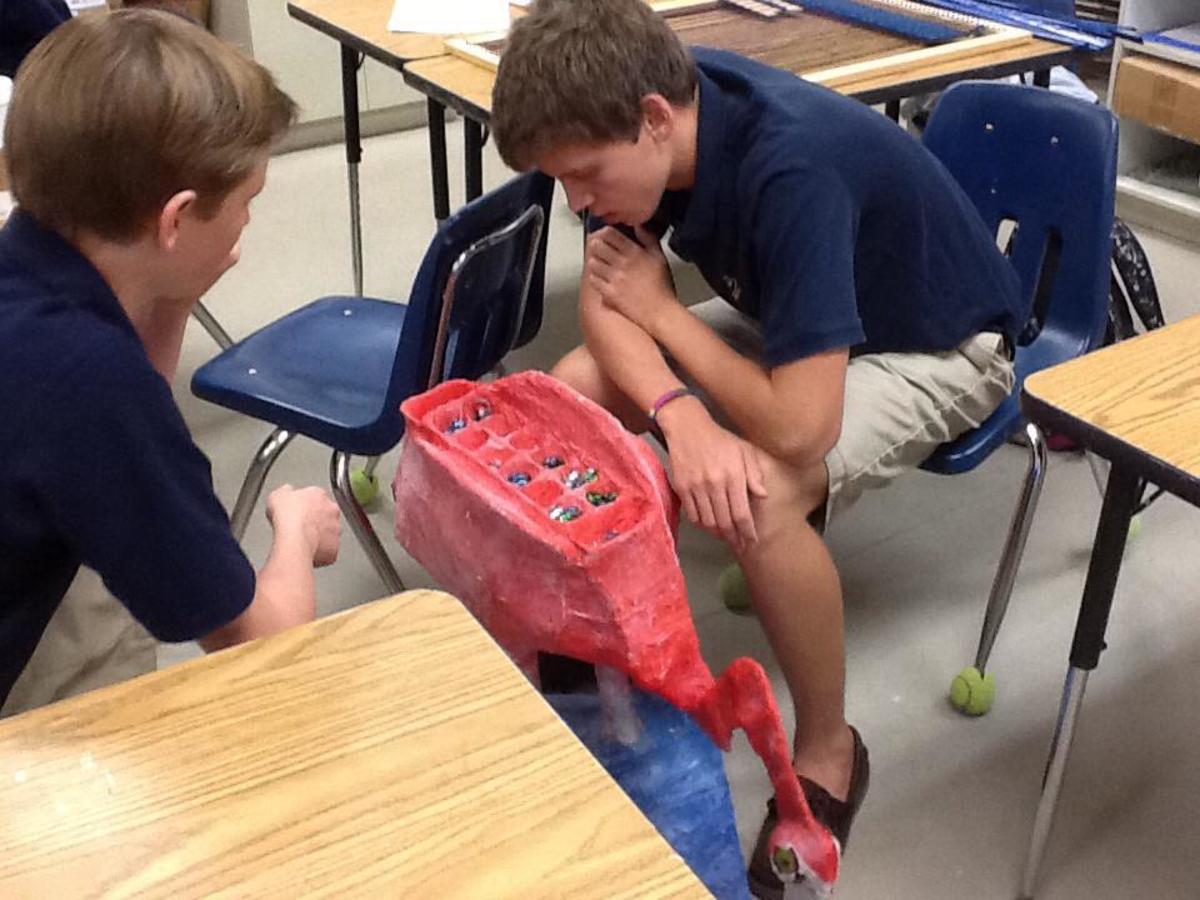 Two of my former students playing an intense game of Mancala, upon completion of their sculpture.