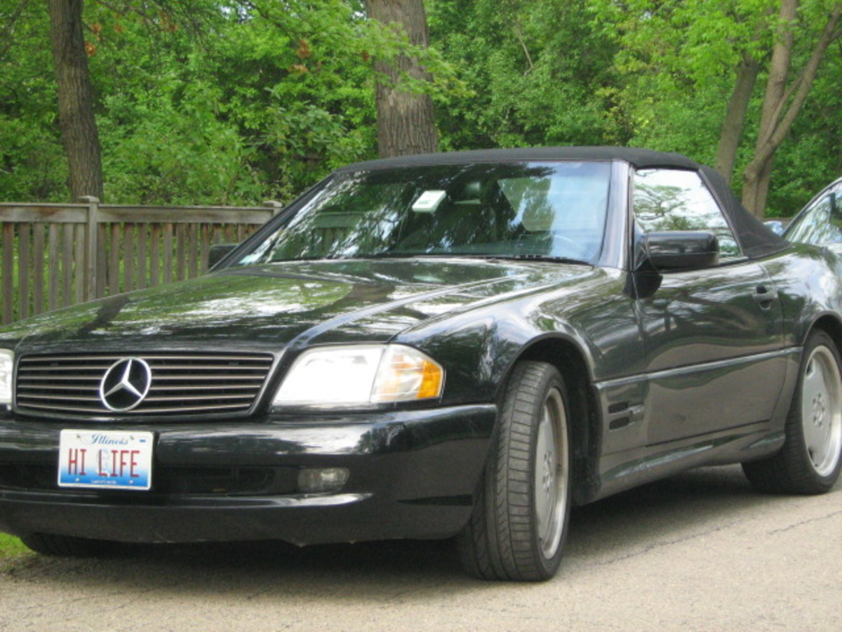 Many nice cars are seen driving through Hinsdale and parked in front of residences