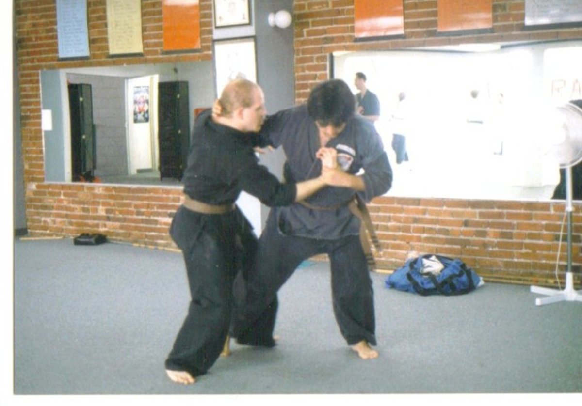 Example of a lock and throw; the wrist is locked, the back of the head grabbed, and the leg is swept. Three points of leverage allow the execution of this throw.