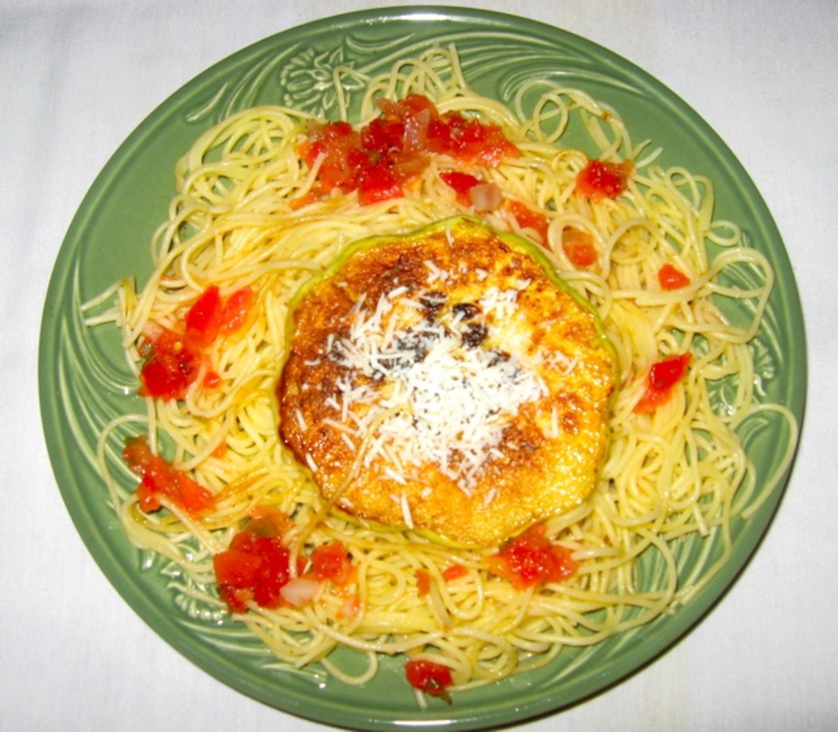Sauted Patty Pan Squash on a bed of angel hair pasta with salsa garnish