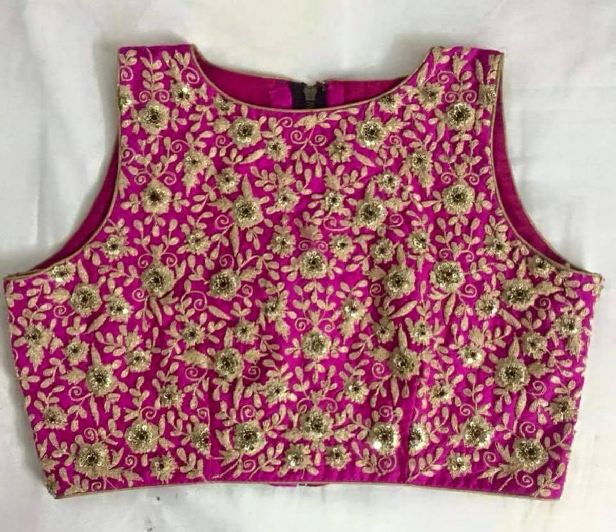Magenta sleeveless crop top for saree with all over dark beige embroidery. small boat neck 