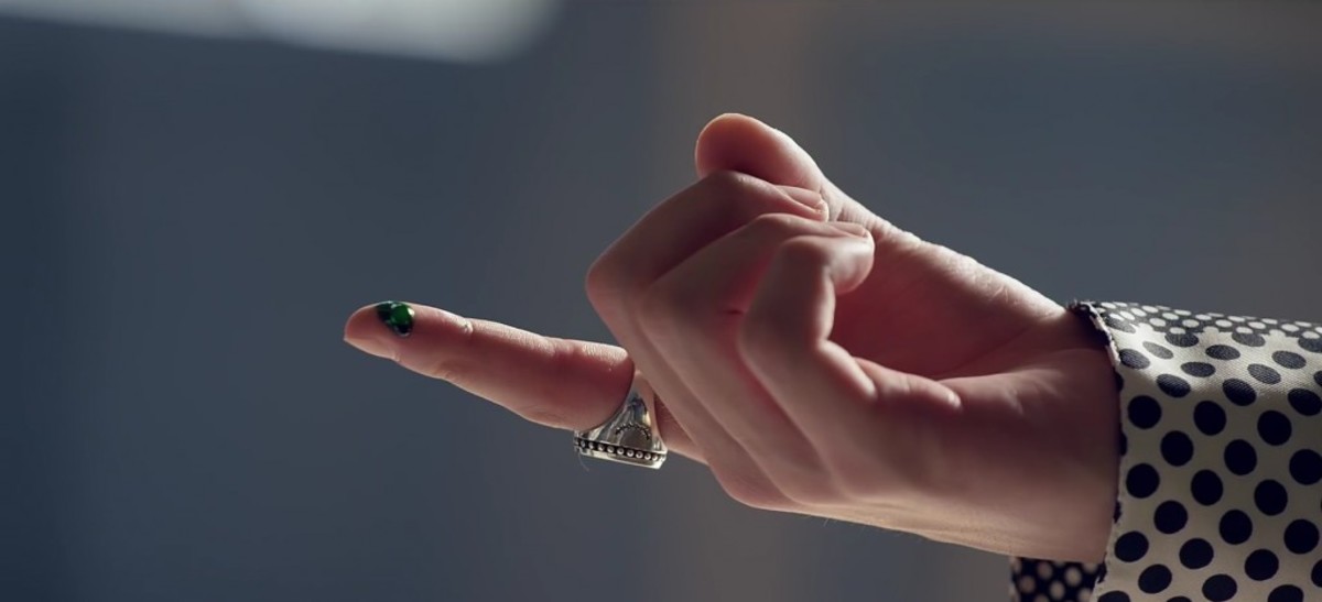 The green drop from the candle that falls on Jungkook's finger.