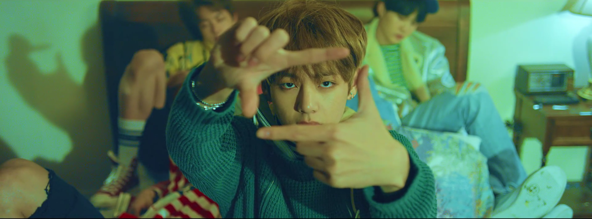 V forming a camera with his fingers.