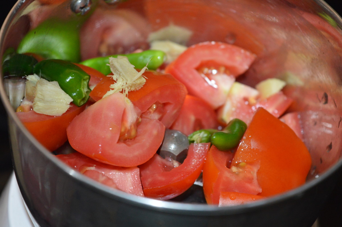 Step two: Grind green chilies, ginger, and tomatoes to get a paste. Set aside.
