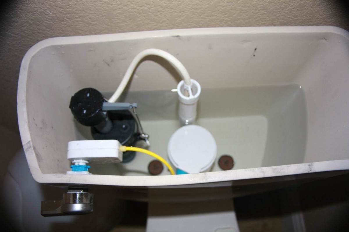 In this photo, you see that I chose to keep my toilet's original valve assembly and simply install only the dual flush valve and handle.
