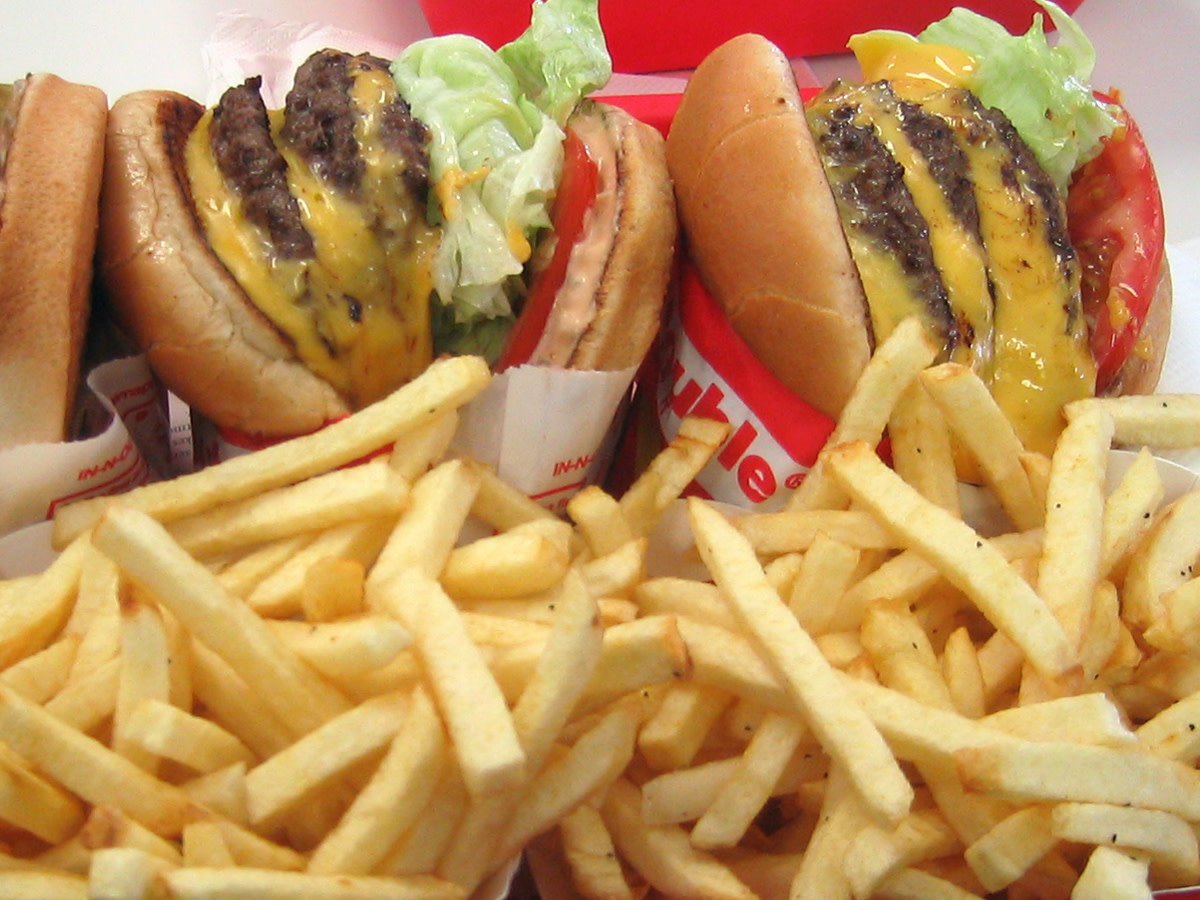 In-n-Out 3x3, three patties and three slices of American cheese and lettuce, tomatoes grilled onion and fries