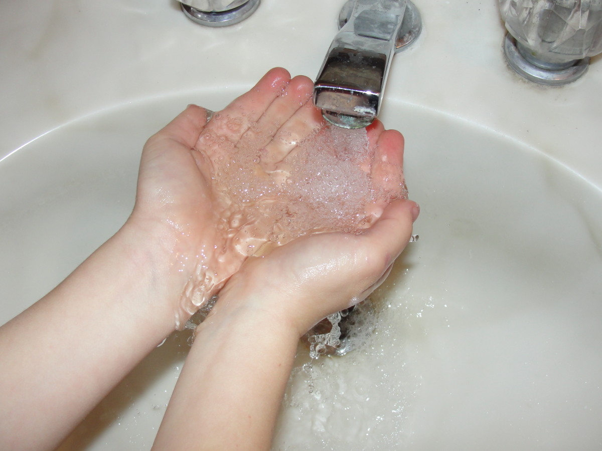 Washing hands with soap and water to remove both glitter germs and real germs