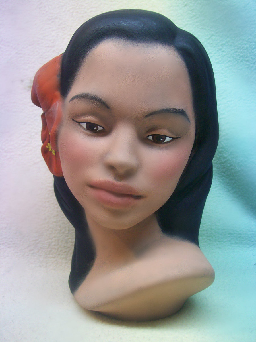 Here is a lovely vintage Polynesian-Hawaiian young girl head bust from the 1960s by an artist in Hawaii. She is a beauty with long black hair adorned with two pretty soft red hibiscus flowers along one side of her head. 