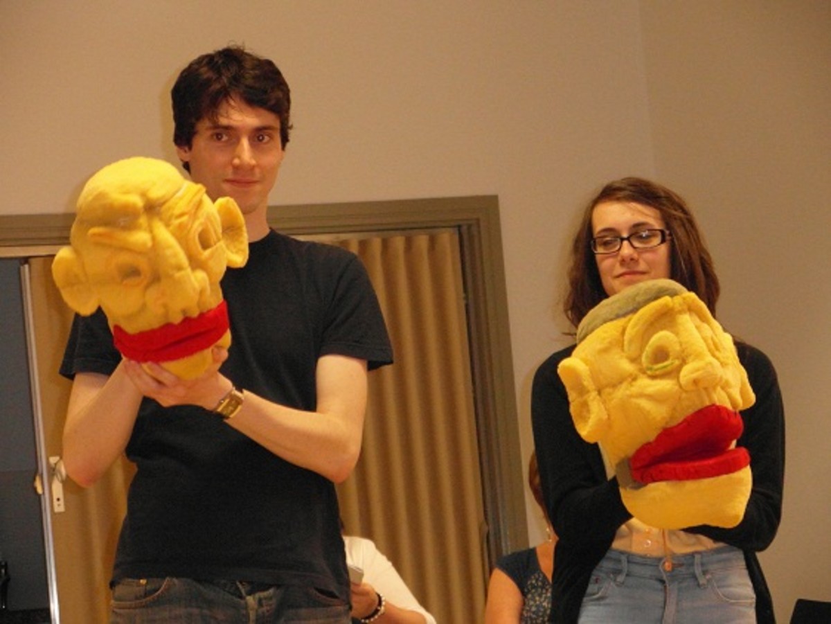 Puppets are worked by actors in rehearsal for Devilish Practices.