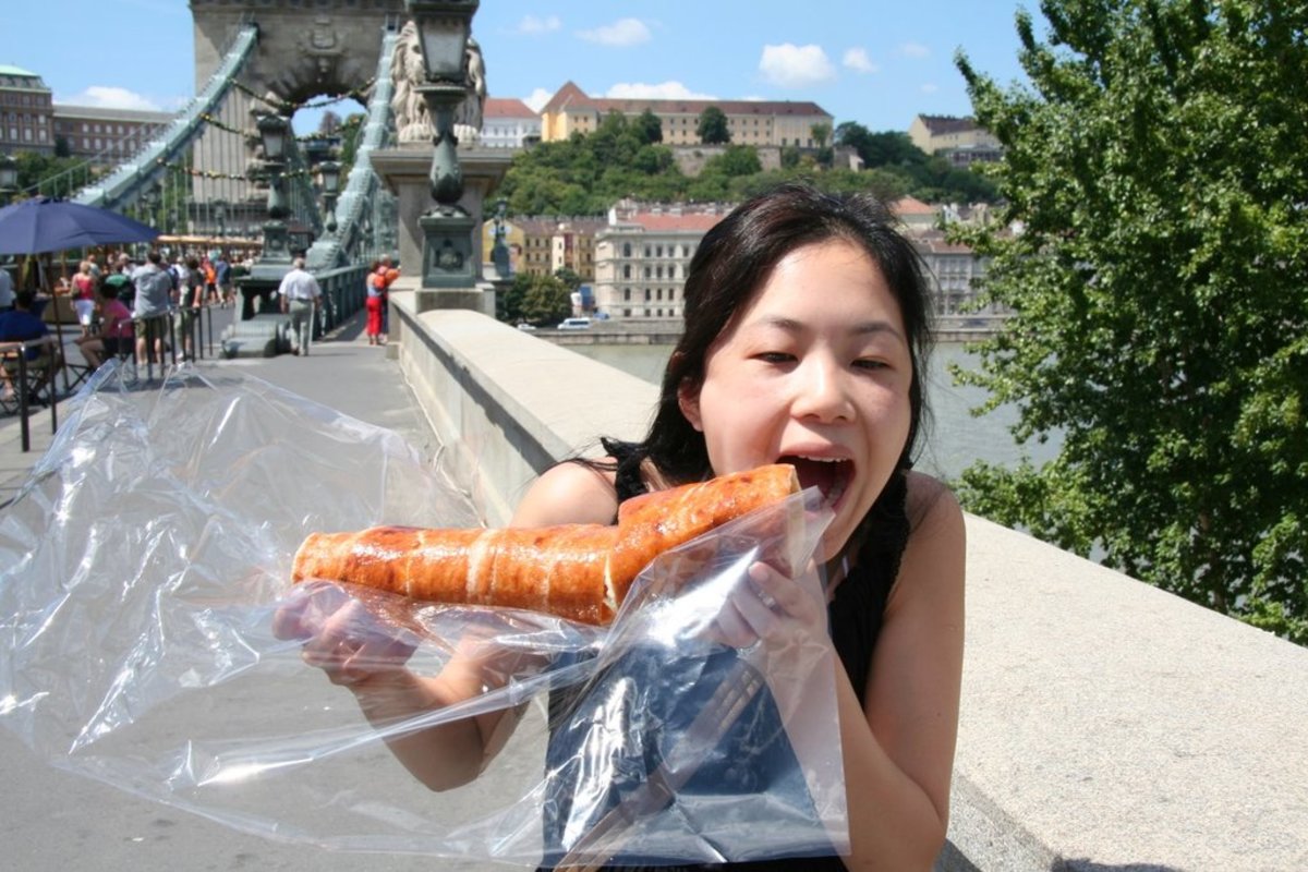 Tourist eating a Chimney Cake in Budapest