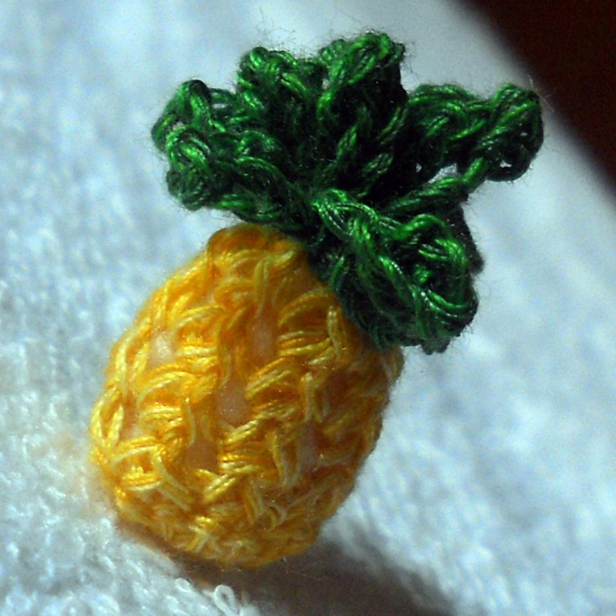 The body of this pineapple amigurumi is crocheted using the pineapple stitches. See how perfectly it mimics the texture of pineapples. That's probably why it's named as such.