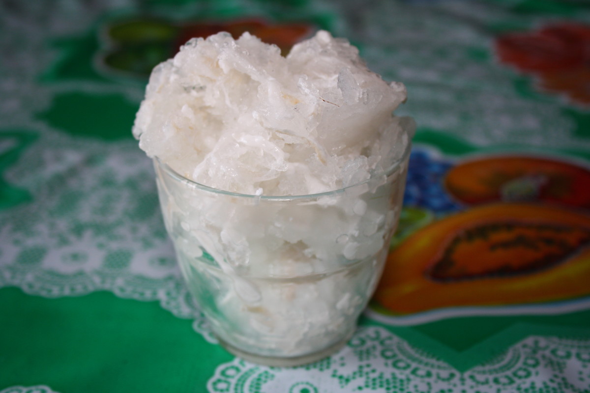 A glass of frozen shreded young coconut with coconut water.