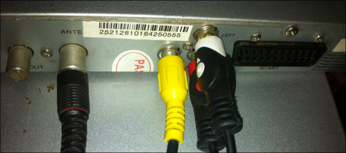 The RCA cables for video (yellow) and audio (red and white), connecting at the back of the decoder. The black plug on the left is the antenna cable. 