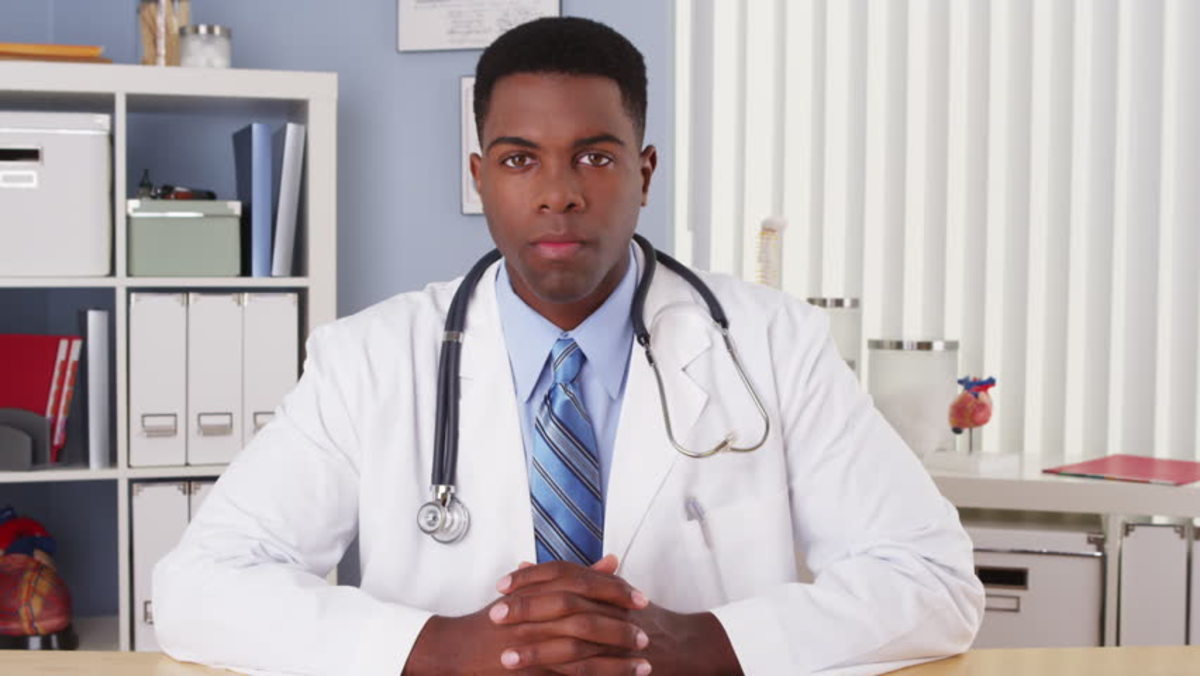 Black doctor talking to camera in video chat