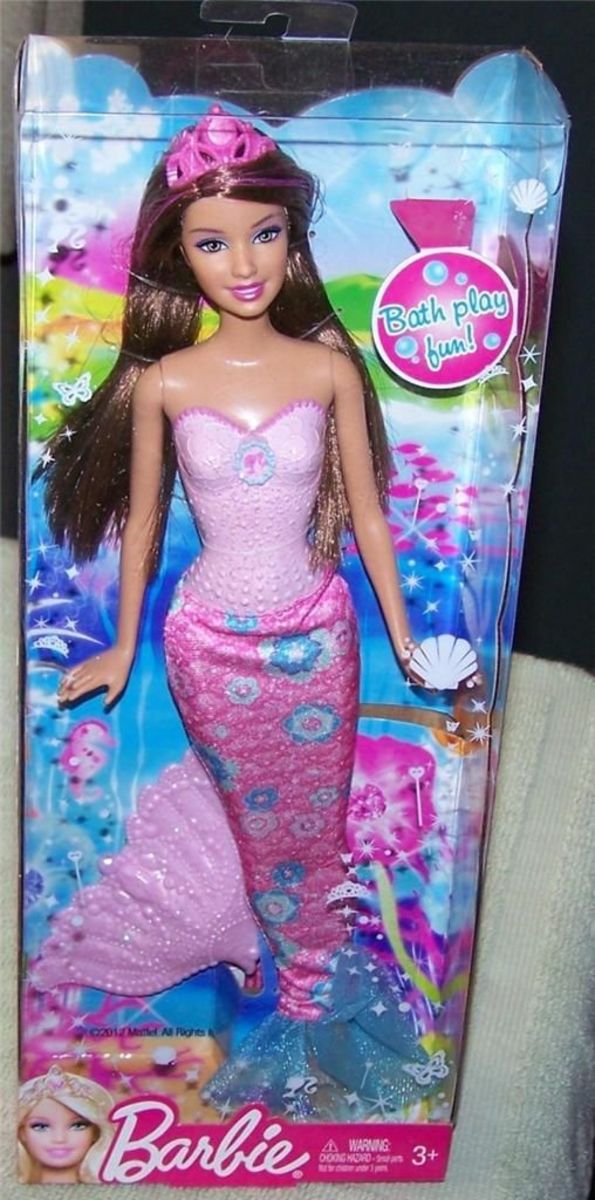 Barbie doll on eBay - dressed in a pink Mermaid outfit complete with fins and long brunette hair