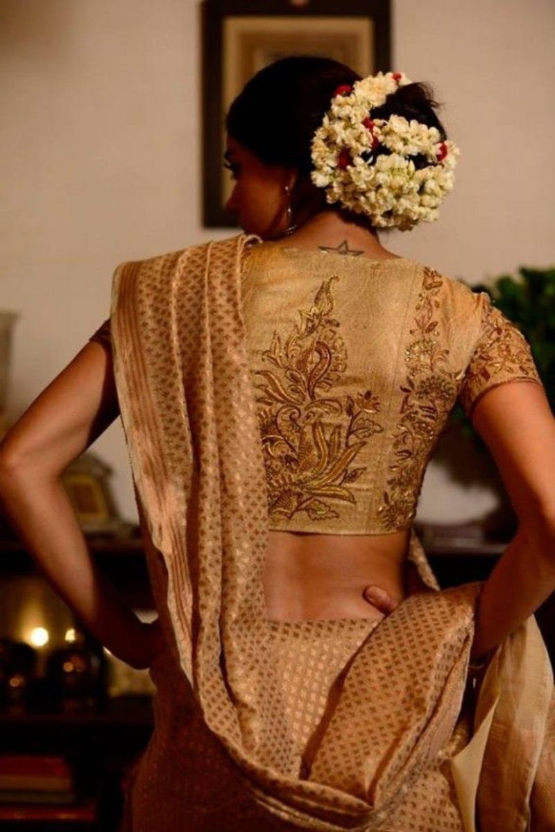 demure yet sophisticated saree blouse back in offwhite and gold design 
