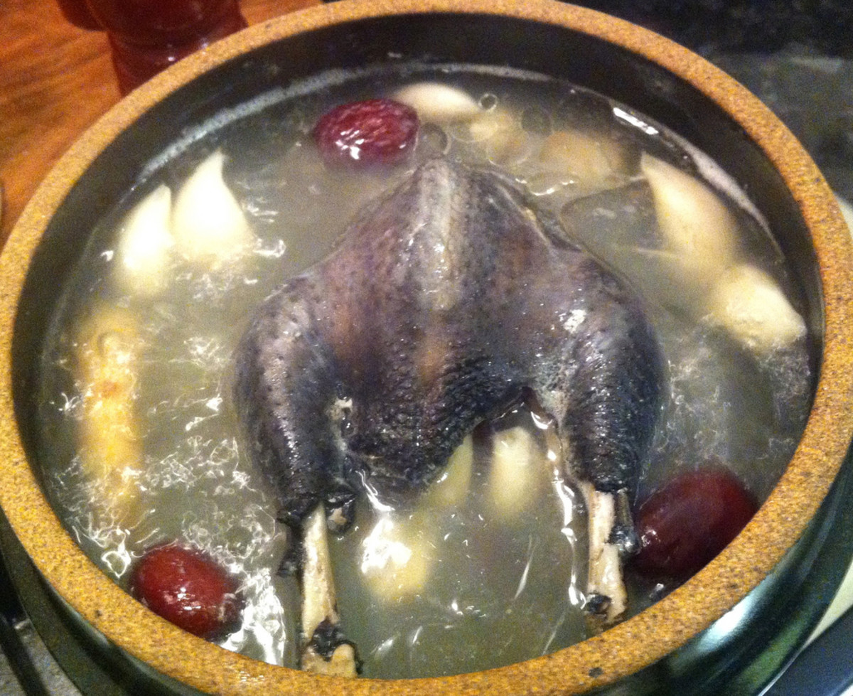 Korean chicken and ginseng soup made with a black silkie chicken. Also called Samgyetang 삼계탕