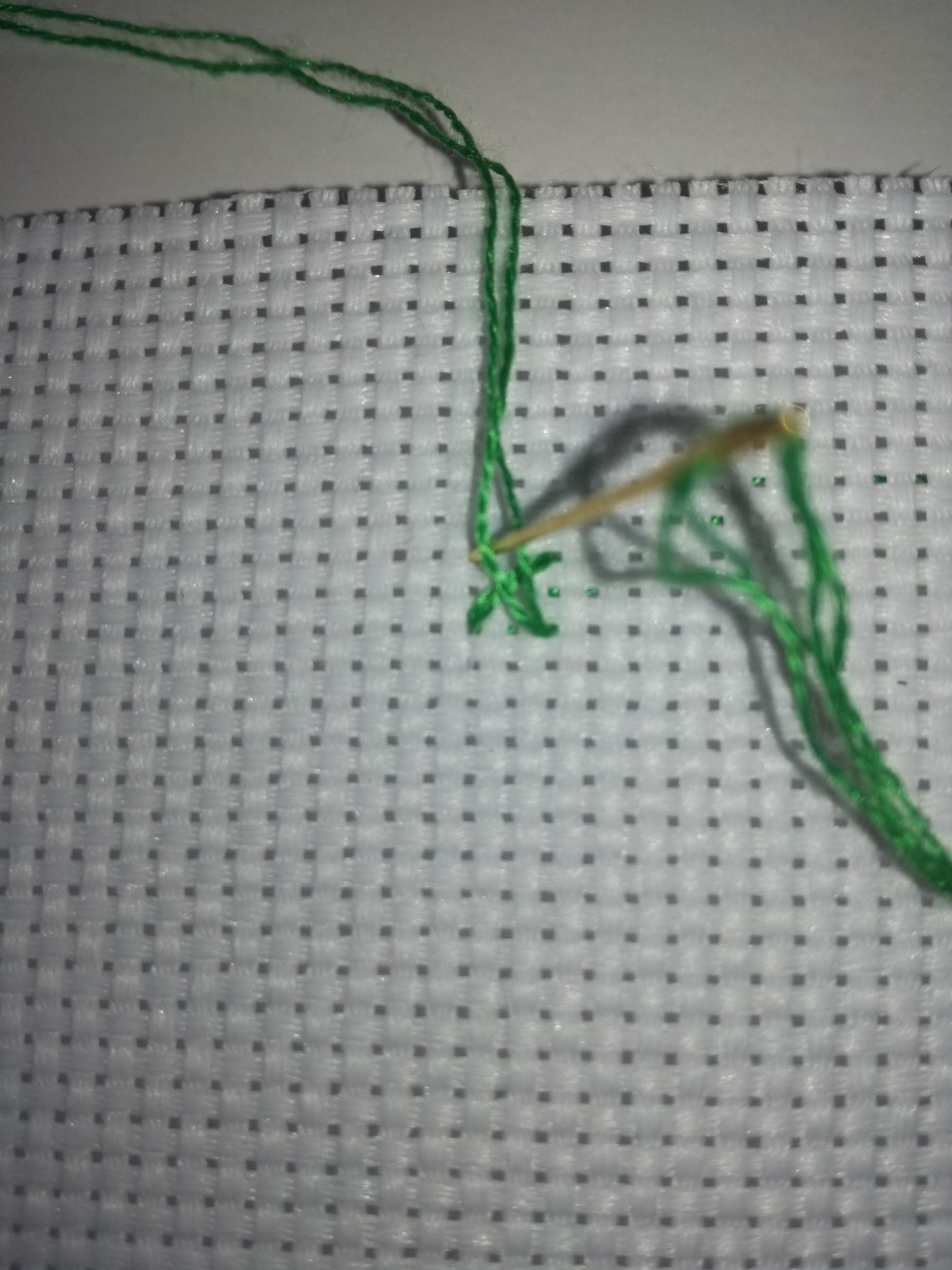Image 2. Part the thread with your needle again when doing the top arm of the stitch.