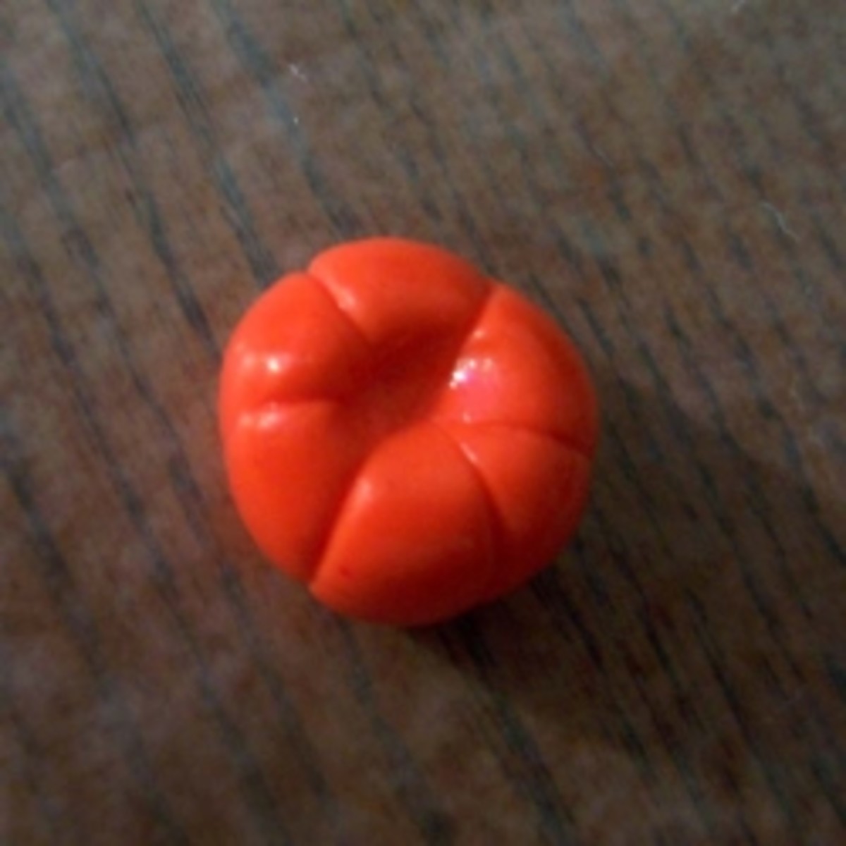 Step 5, a dent pushed into the top of the orange ball.
