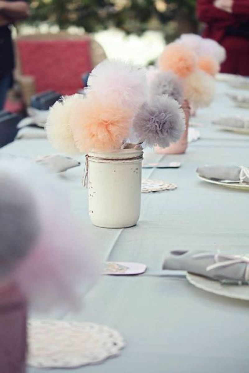 These tool pom poms centerpieces are easy to make and budget friendly, You can find containers priced within reason. You can make these ahead of time and they will never wilt.