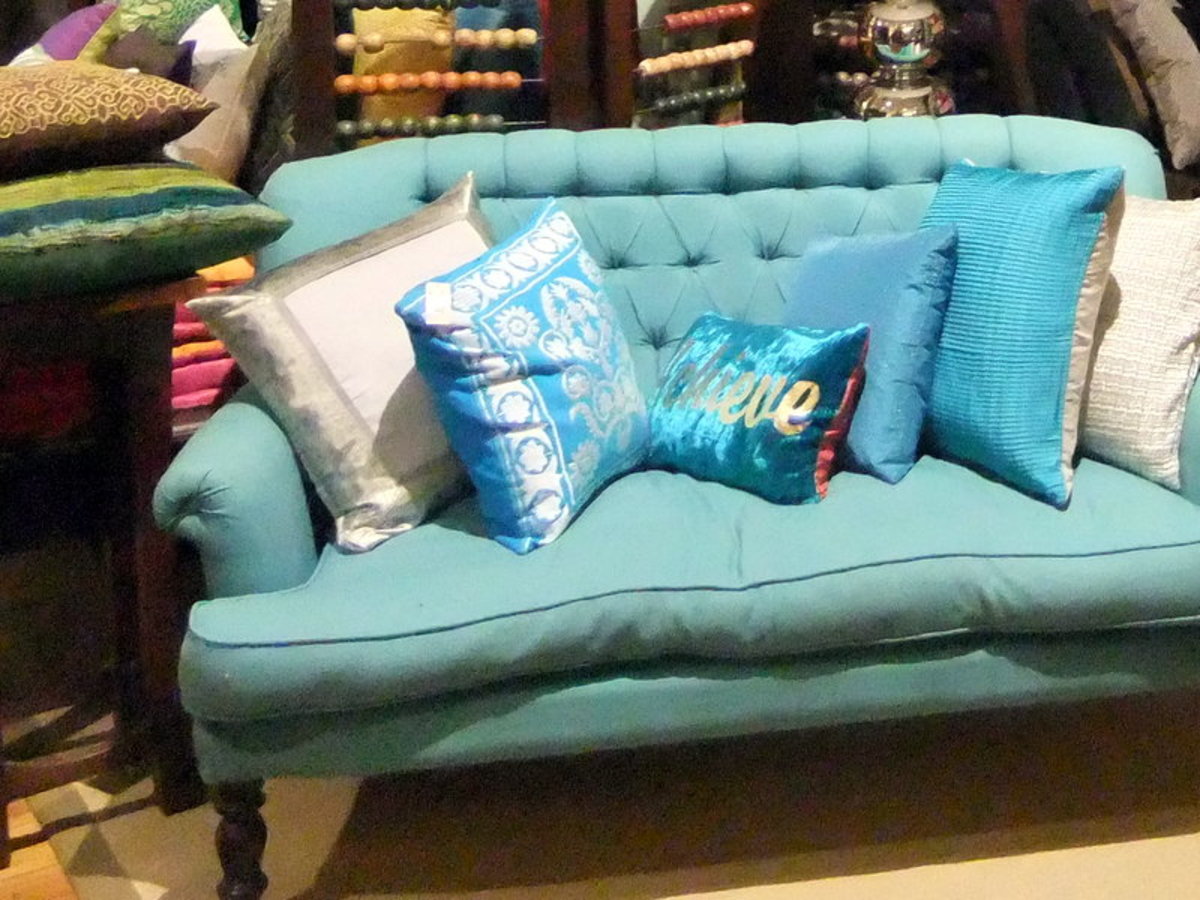 2. Use different fabrics, but similar color tone for your throw cushions can be one way to decorate your sofa