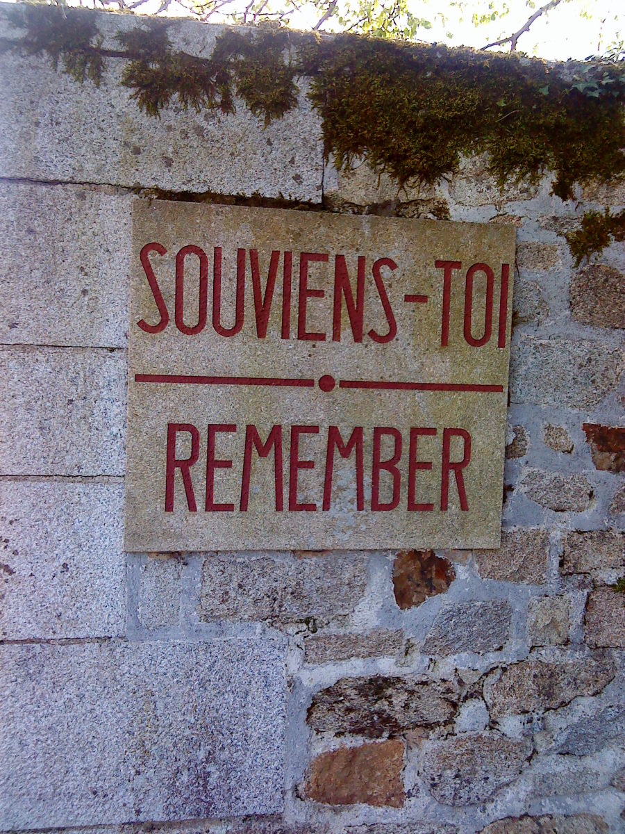 Simple plaque near the entrance to the village.