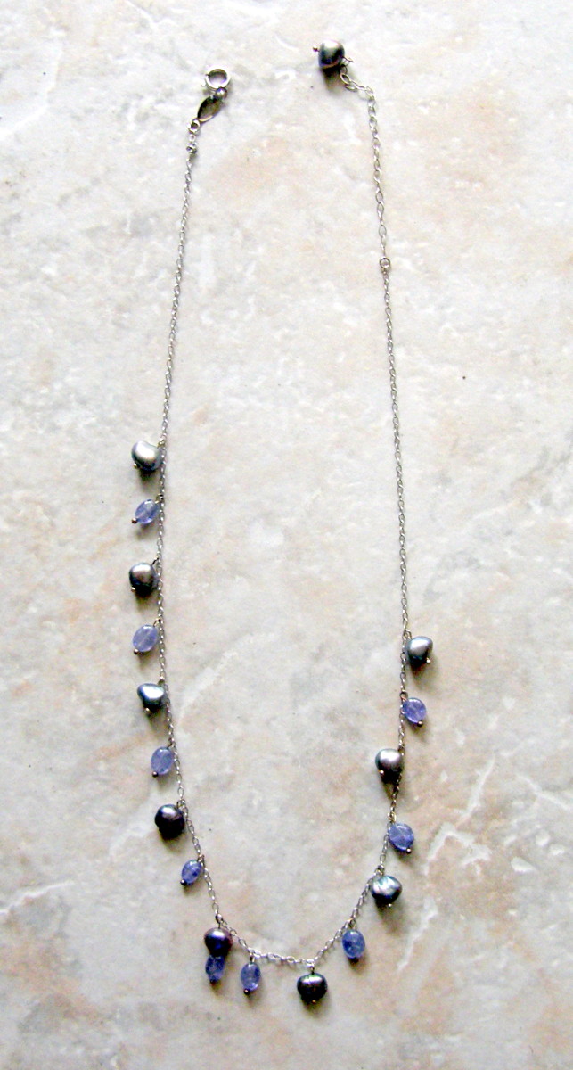Black pearl necklace with tanzanite set in white gold