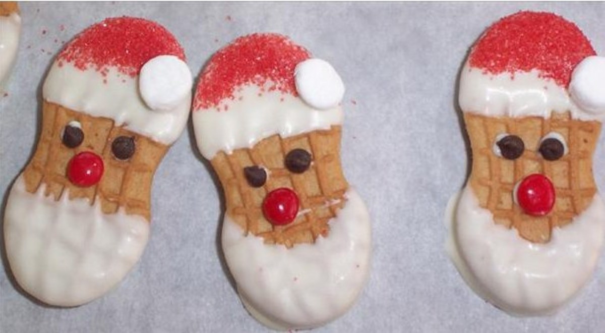 Nutter Butter Santa cookie faces. Use white icing, chocolate chips for eyes, red hots for the nose, red sugar sprinkles for the hat and miniature marshmallow for the ball on Santa's hat.