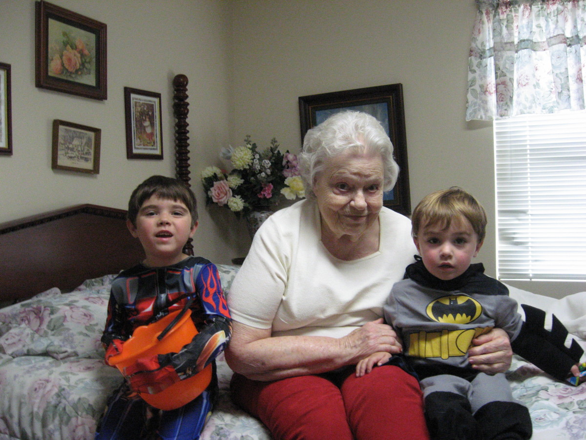 Mom in the Alzheimer's unit with two of her great-grandchildren on Halloween.
