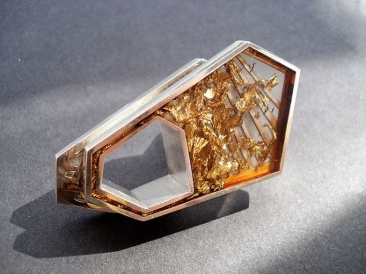 Ultra modern ring with a section of resin containing gold foil pieces.