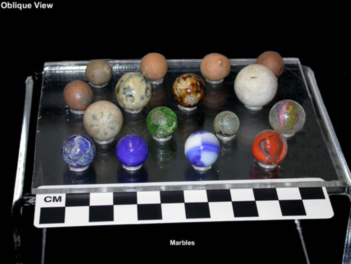 A collection of historical marbles, including china marbles and handmade German marbles.