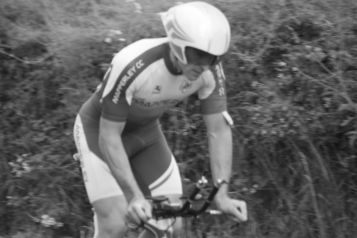 In action during a time trial wearing an aero cycling helmet