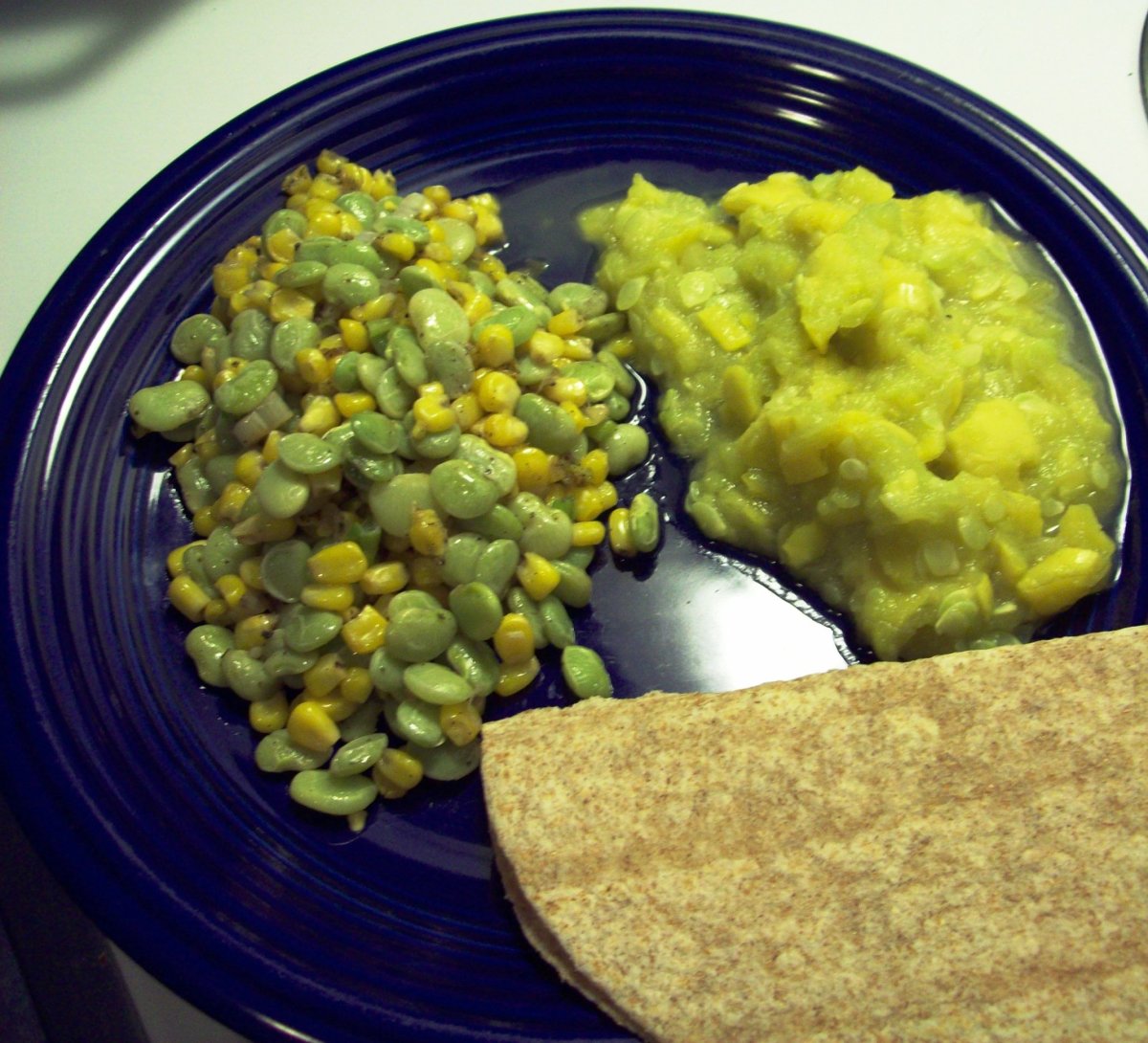 Succotash, mashed squash and a tortilla.  Though it's not the most colorful meal in the world, it is full of soul-filling goodness.  For added color, add slices of tomato, avocado and cheese to the meal as delicious sides.