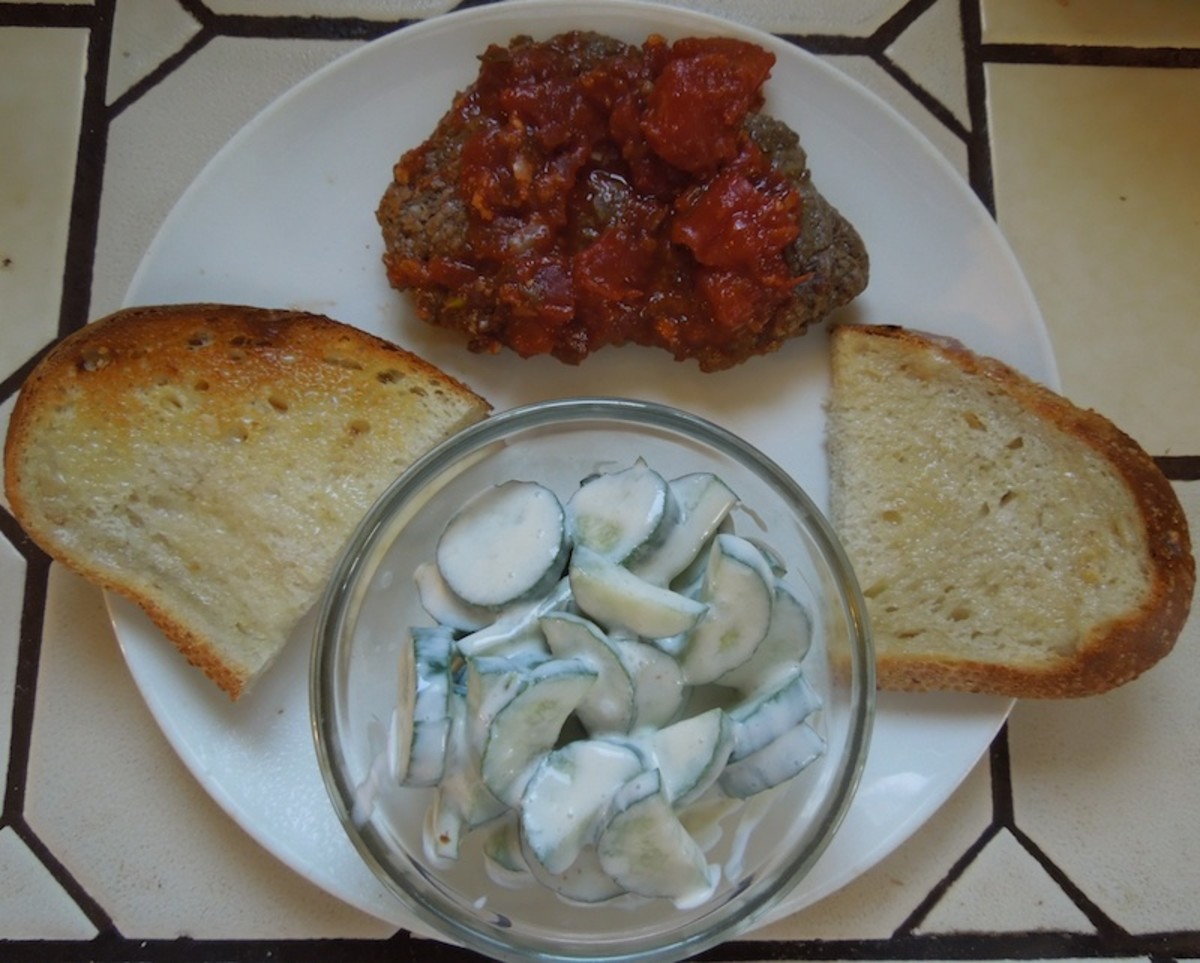 Italian cube steaks served with creamy cucumber salad and sourdough garlic bread