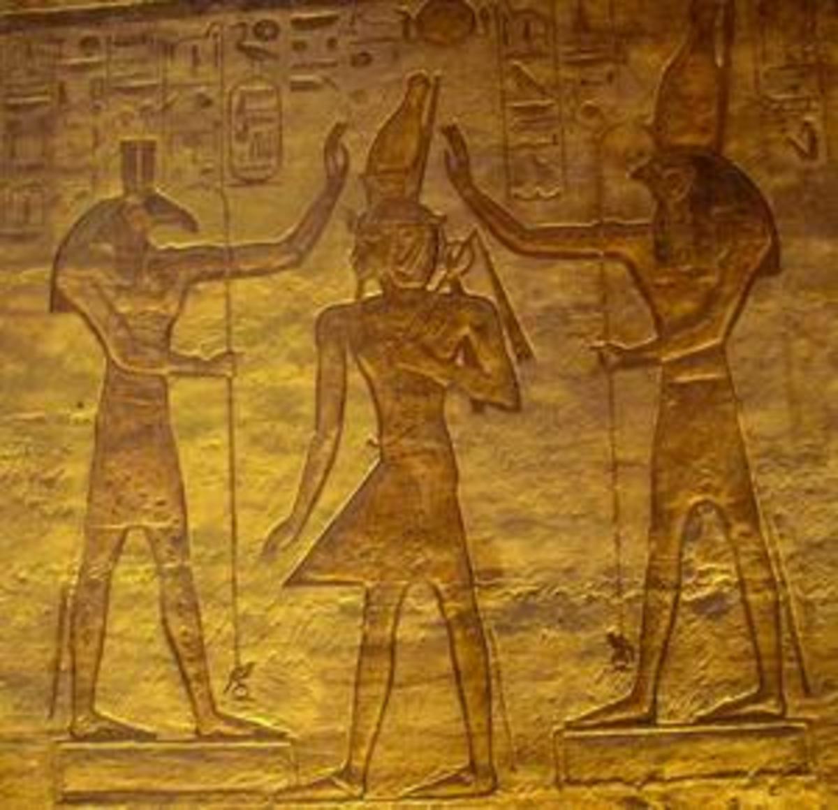 This is a common sight in tombs. Pharaohs wanted to show they were balanced, like Maat. So they depicted themselves (centre) with Seth (left) and Horus (right)