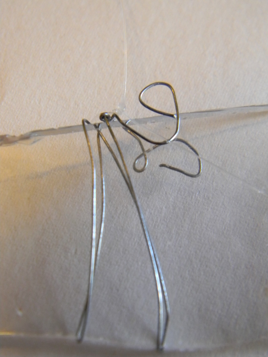 Wrapping glass pieces in wire is much easier than drilling holes in them.