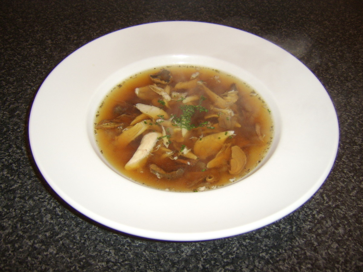 Chicken and porcini mushroom soup is garnished with some freshly chopped chives